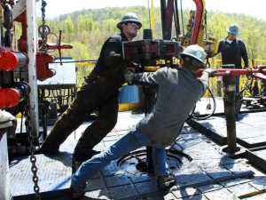Workers move a section of well casting at a natural gas well site in Pennsylvania. Energy expert Daniel Yergin says that in addition to trucks and traffic, natural gas production can bring jobs and economic growth to gas-rich areas.